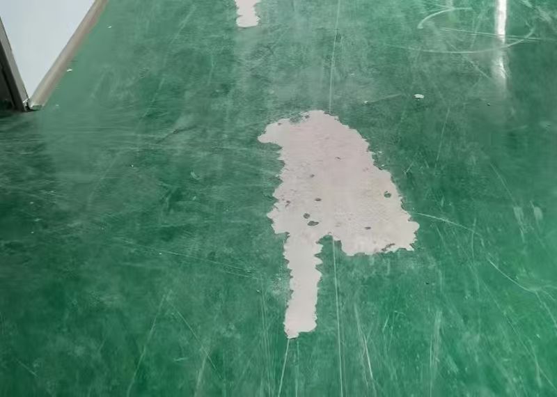 Structural concrete floor spalling and cracks caused by dropped pallets and heavy equipment impact