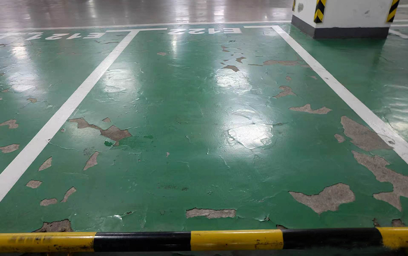 Premium floor coating failure showing delamination, peeling, and flaking from moisture vapor transmission
