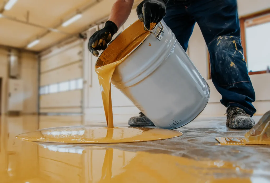 Worker applying high-performance polyurea coating in commercial facility