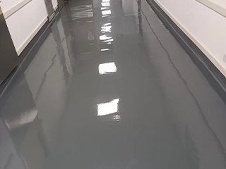 High-moisture concrete primer system improving adhesion and substrate stability for durable resin flooring systems