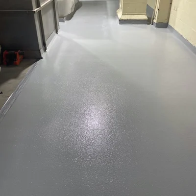 Self-leveling cementitious urethane flooring system with smooth seamless surface